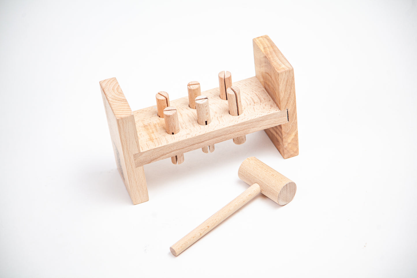 WOODEN HAMMER AND PEG POUNDING
