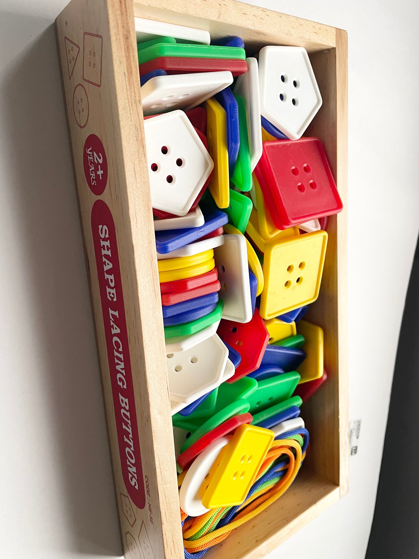 LACES IN A WOODEN TRAY